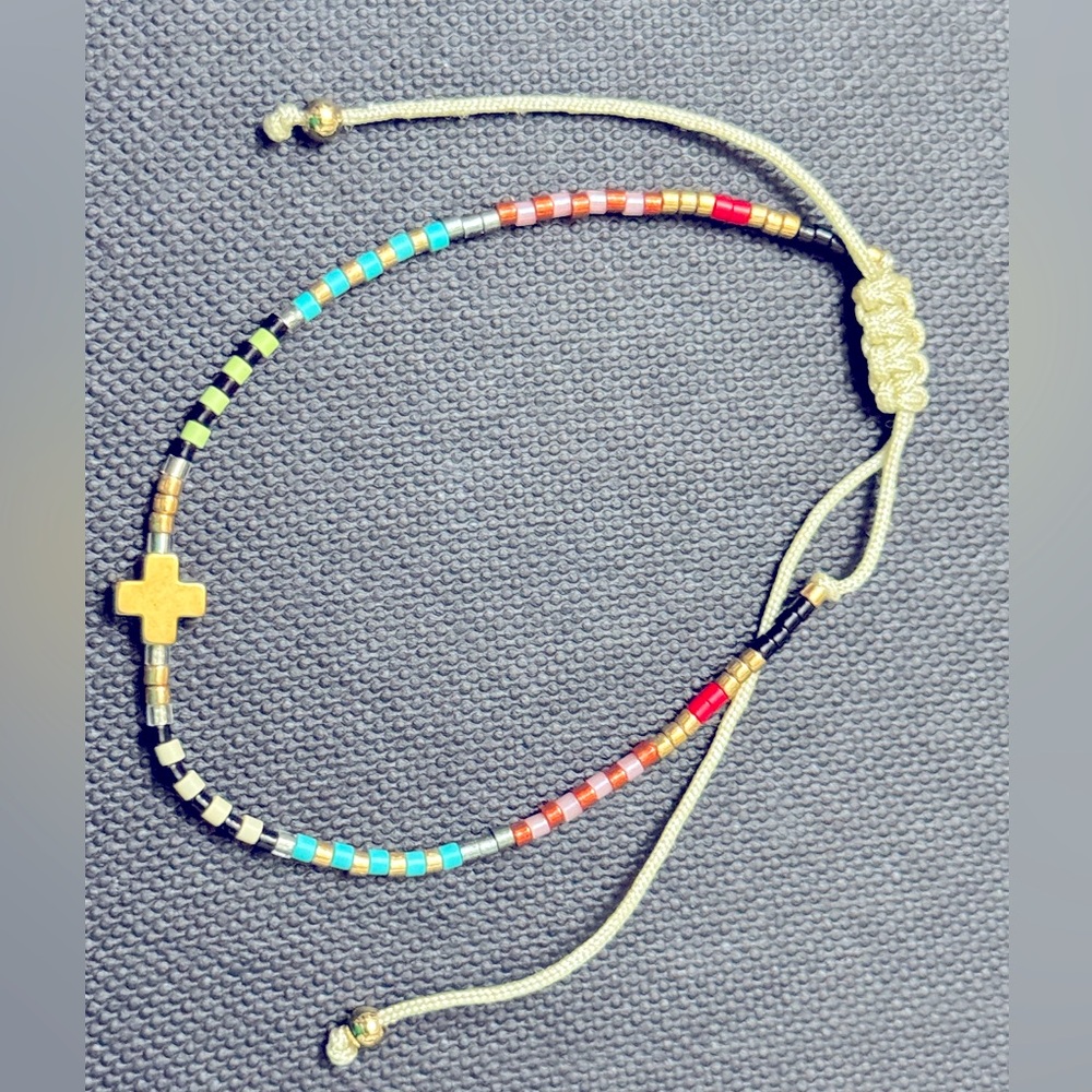 Micro-bead pull string bracelet with cross